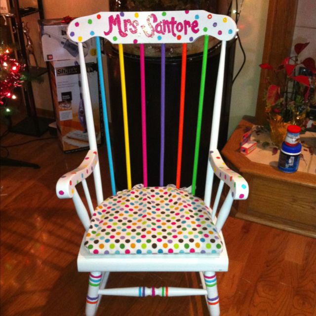 a white rocking chair decorated with multicolored polka dots and the words mrs jambore on it