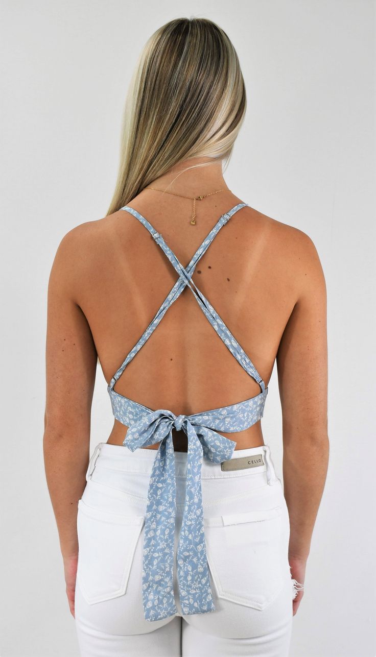 Great trendy little top. This tiny triangle crop top has adjustable straps that cross in the back for support and a back tie that customizes the fit. Wear it with a skirt for a delicate look, or pair it with your favorite jeans to add some edge. Color-Light Blue Floral (Also available in Gold Floral) 100% Rayon Chic Triangle Crop Top With Built-in Bra, Spring Tops With Built-in Bra And Strappy Back, Spring Backless Halter Top With Built-in Bra, Chic Crop Top With Built-in Bra And Strappy Back, Vacation Tops With Tie Back And Backless Shape, Vacation Tops With Tie Back And Backless Design, Vacation Backless Top With Tie Back, Vacation Tie Back Backless Tops, Chic Triangle Crop Top For Day Out