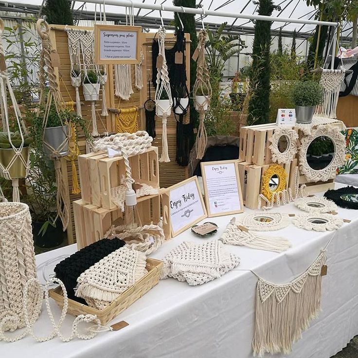 a table topped with lots of different types of handmade baskets and bags on top of it