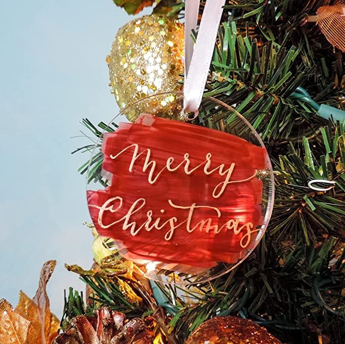 a christmas ornament hanging from the top of a tree