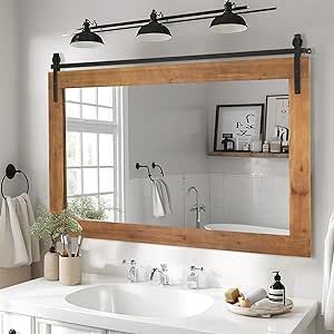 a bathroom with a large mirror above the sink