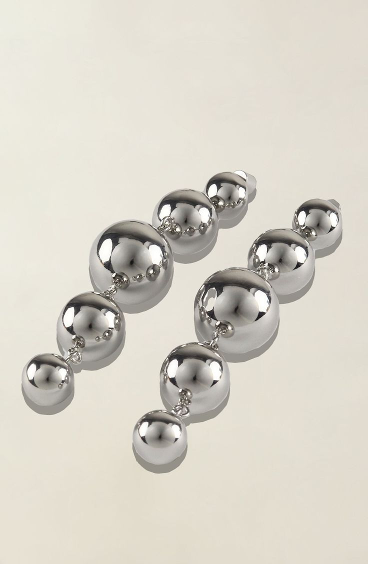 Elevate your style with our exquisite Multi-Sphere Shaped Drop Earrings, available in sleek silver plating. Crafted with meticulous attention to detail, these earrings are a testament to timeless elegance and contemporary charm. Due to hygiene-related reasons, this item may not be returned. Weight 38 g Modern Silver Chandelier Earrings For Party, Modern Silver Teardrop Chandelier Earrings, Modern Silver Linear Drop Earrings, Silver Metal Linear Earrings, Silver Metal Linear Drop Earrings, Modern Silver Metal Chandelier Earrings, Silver Sphere Metal Earrings, Modern Silver Linear Earrings For Party, Silver Sphere Earrings For Pierced Ears