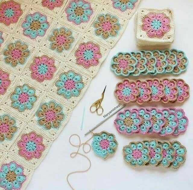 the crochet is laying on the table next to some scissors and other items