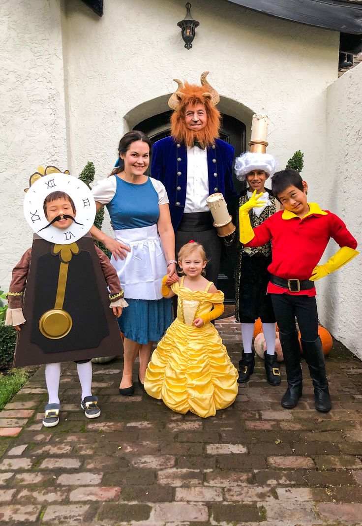 a group of people in costumes posing for a photo with one child and two adults