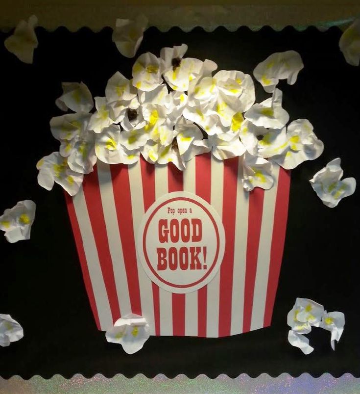 an image of a popcorn box with flowers on the side and words good book above it