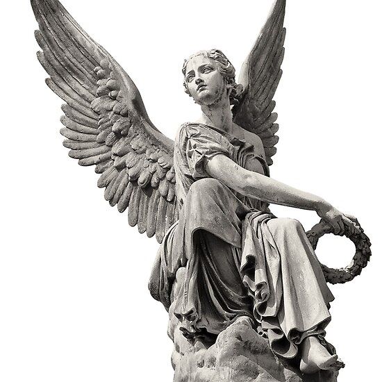 an angel statue sitting on top of a rock