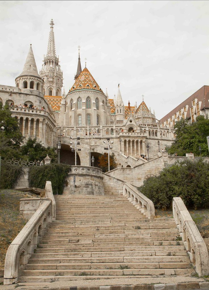 an old castle with stairs leading up to it