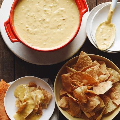 chips, dip and tortilla are on plates next to bowls with dipping sauce