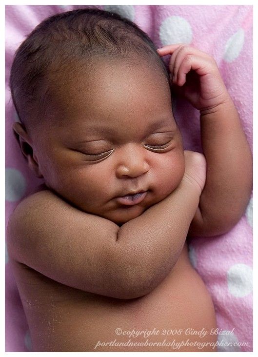 a close up of a baby sleeping on a blanket