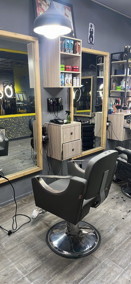 a hair salon with chairs, mirrors and lights on the floor in front of it