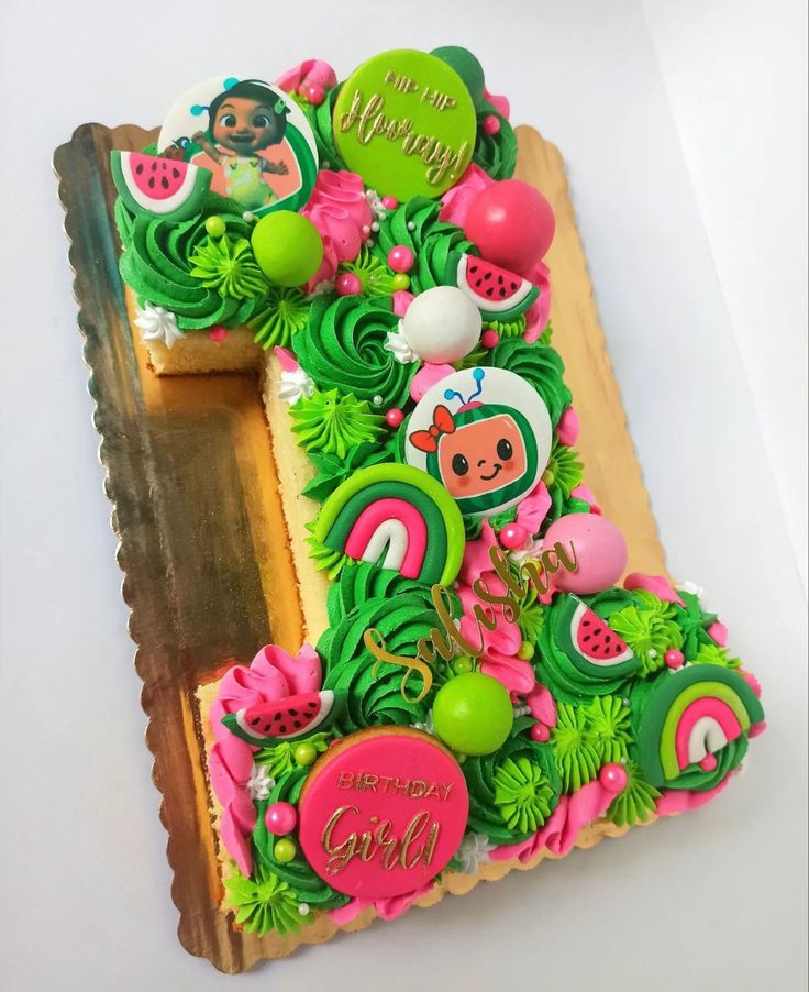 there is a cake decorated to look like the letter f with fruits and vegetables on it