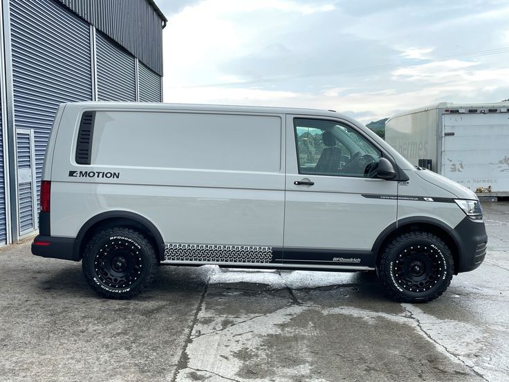 a white van parked in front of a building