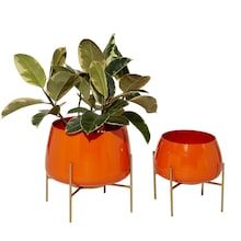 two orange planters sitting next to each other on metal stands with leaves in them