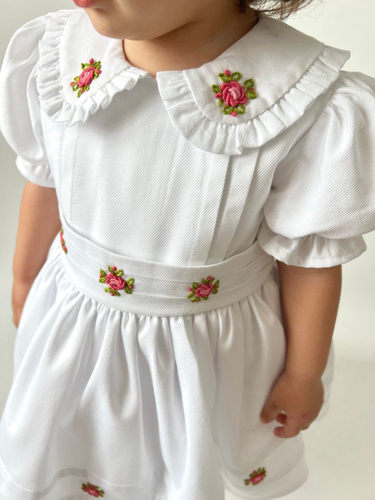 ✿ABOUT THIS DRESS ✓Our handmade dress is made from high-quality cotton fabric, this dress features a fluffy tutu-supported skirt lined with soft cotton for ultimate comfort. ✓The frilled collar and rib impositions on the front part of the dress and skirt add a touch of elegance, while the bow tie belt accentuates your child's waistline for a flattering fit.  ✓And flower embroideries adorning the dress - each hand-crafted with exquisite attention to detail by our skilled artisans.  ✿FABRIC INFORM Embroidered Fitted Dress For First Communion, Fitted Embroidered Dress For First Communion, Fitted Cotton Baptism Dress With Ruffles, White Embroidered Dress For Baptism, Embroidered Fitted Dress For Baptism, Fitted Floral Embroidery Baptism Dresses, Fitted Embroidered Dress For Baptism, White Floral Embroidered Dress For Baptism, Embroidered Cotton Dresses For Baptism