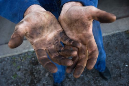 two hands that are covered in dirt and one is holding the other's hand