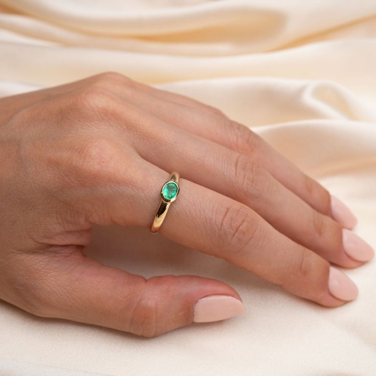 14k Gold Emerald Bezel Ring Our new stunning 14k Gold Emerald Bezeled Ring is beautiful ring that stands alone with its stunning green hues. Hand set by us, for you in a simple yet timeless 14k Bezel Ring. Featuring a 1/2 Carat Genuine Emerald forged in 14k Solid Gold Band Width: 5.25mm tapering down to 3.25mm at the shank Stone/Bezel Size: 6mm x 4mm Built to last a lifetime and more. Due to the handmade nature of this ring, please allow 1 - 3 weeks for processing. Heirloom Solitaire Emerald Ring, Fine Jewelry Bezel Setting Ring For May Birthstone, Fine Jewelry Bezel Set Ring With May Birthstone, Emerald Ring With Bezel Setting, Opal Ring With Bezel Setting For Promise, Opal Ring With Bezel Setting And Round Band, 14k Gold Bezel Set Ring For May Birthstone, Emerald Promise Ring With Bezel Setting And Round Band, Fine Jewelry Birthstone Ring With Bezel Setting For Promise