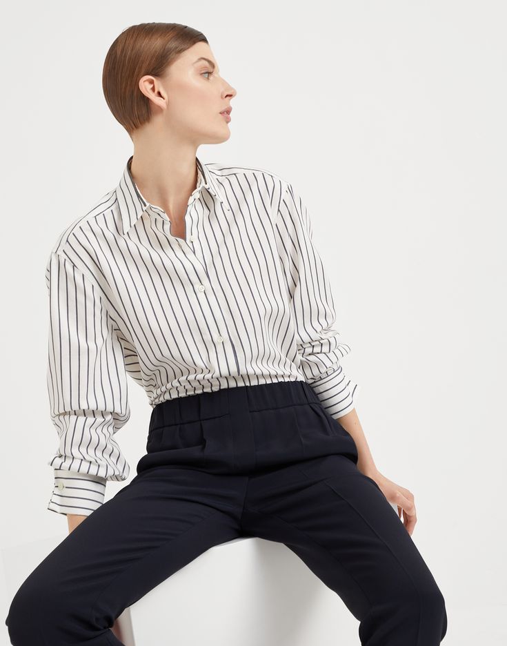 Striped cotton twill shirt with shiny collar detail The iconic embellishment of the Brunello Cucinelli collections illuminates this twill shirt with a contemporary feel. The classic striped pattern runs along the soft surface of the garment, characterized by a regular silhouette. An insert embroidered with fine rows of shiny monili illuminates the collar, giving the shirt a radiant sparkle. Chic Business Casual Shirt With Fold Down Collar, Elegant Top With Striped Fold Down Collar, Chic Fold Down Collar Shirt For Office, Modern Shirt With Concealed Placket For Work, Modern Tops With Striped Collar For Work, Modern Top With Striped Collar For Work, Elegant Top With Striped Spread Collar, Timeless Office Wear Tops With Spread Collar, Timeless Spread Collar Tops For Office Wear