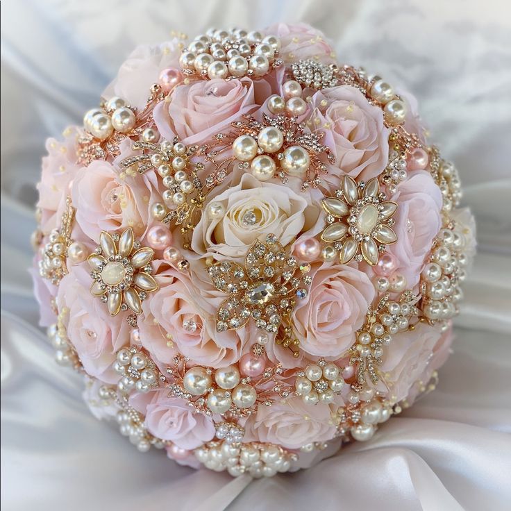 a bridal bouquet with pink roses and pearls