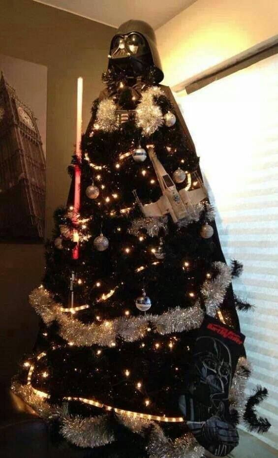 a darth vader christmas tree with lights and star wars decorations on the top