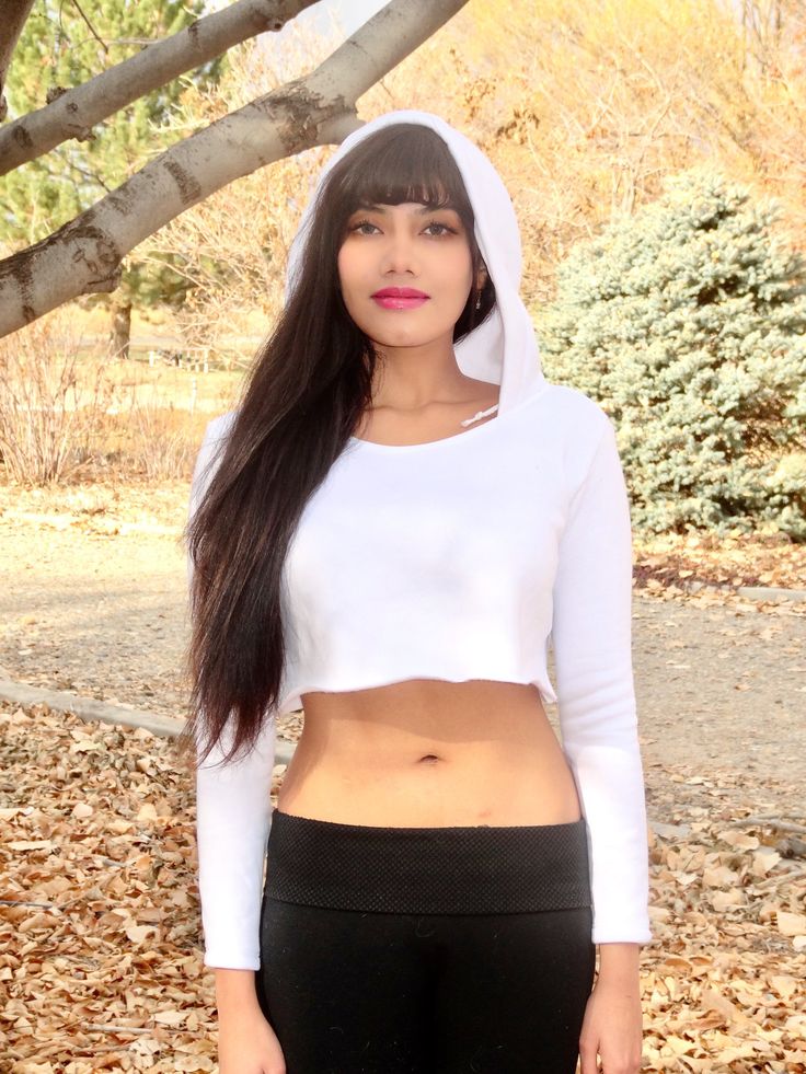 "This white long sleeve cropped hoodie has a soft feel and a stylish and edgy fit that is loose-fitting and comfortable. This boxy crop top is made from a soft fleece fabric.  Best paired with: Cutoff shorts, your favorite pair of jeans, a nice mini-skirt, or your favorite exercise wear and lounge wear. The model is 5'3\" and wearing a size small.  Keep in mind that this top, especially in small, is very short; order a size up if you want the top to be longer. Size Chart (inches):                              S                  M           L Bust                      26-31   32-35    35-38 Natural Waist      26            36    36 Length                      12             16     16  Materials:  30% cotton, 70% polyester. Custom print on this crop top: Yes. You can request your own design White Long Sleeve Crop Top For Winter, Winter Cotton Stretch Crop Top, Winter Stretch Cotton Crop Top, Spring Cropped Hoodie With Stretch, White Cropped Sweatshirt For Winter, Stretch Cropped Hoodie For Spring, Spring Cropped Stretch Hoodie, Hooded Crop Top For Winter, Trendy Cropped Hoodie