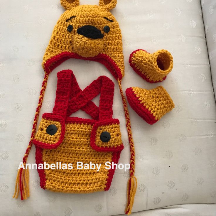 a crocheted winnie the pooh hat, booties and diaper cover