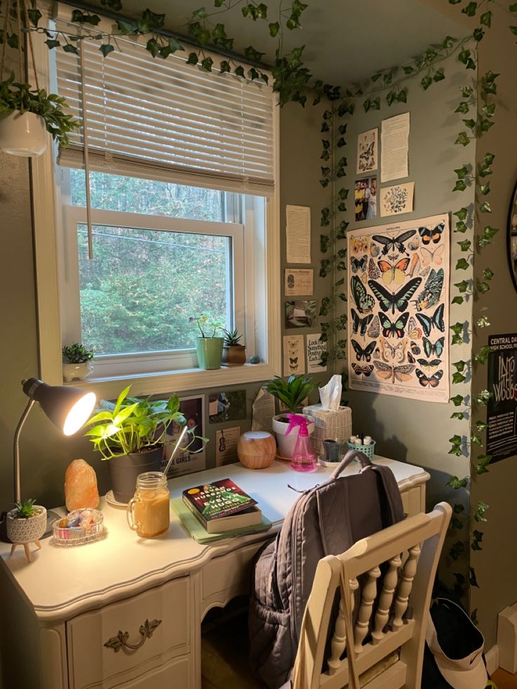 a room with a desk, chair and plants on the window sill in it