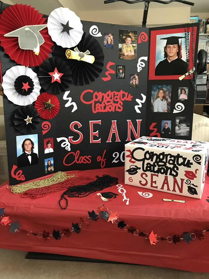 a table topped with pictures and decorations on top of a red cloth covered tablecloth