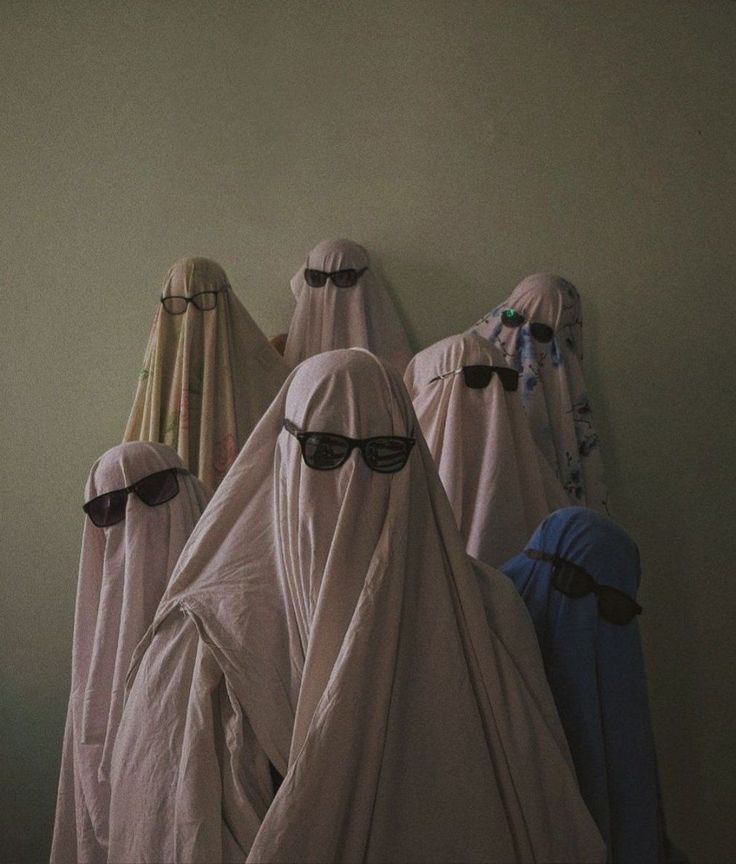 four women in white veils with sunglasses on their heads