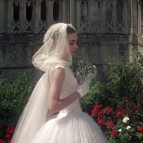 a woman in a white wedding dress and veil