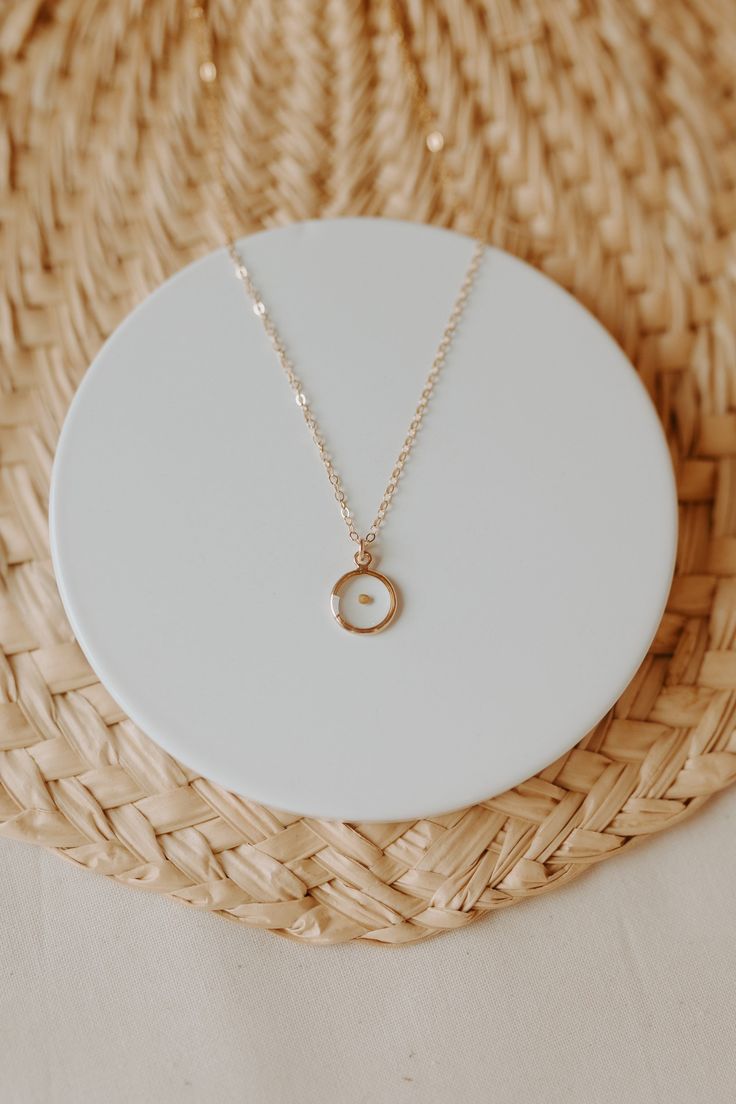 "Dainty, minimalistic, gold filled necklace that represents so much more. Encased in a small gold filled bezel is a REAL mustard seed. Serving as a meaningful reminder to have faith in Christ. Each necklace is packaged in a white box and comes with a keepsake card. Minimal in design, but packed full of meaning. Perfect for every day wear. Featuring a 16\" chain. These necklaces are 14k gold filled, which means they are NOT plated. They will not change colors on you or turn your skin green like p Minimalist Personalized Recycled Gold Necklace, Minimalist 14k Gold Filled Initial Necklace Gift, Minimalist 14k Gold Filled Initial Necklace, Minimalist Recycled Gold Birthstone Necklace, Minimalist Birthstone Necklace In Recycled Gold, Minimalist Personalized Charm Necklaces In Recycled Gold, Everyday White Charm Necklace In 14k Gold Filled, Minimalist Jewelry With Birth Flower Initial Pendant, Minimalist Personalized Charm Necklace In Recycled Gold