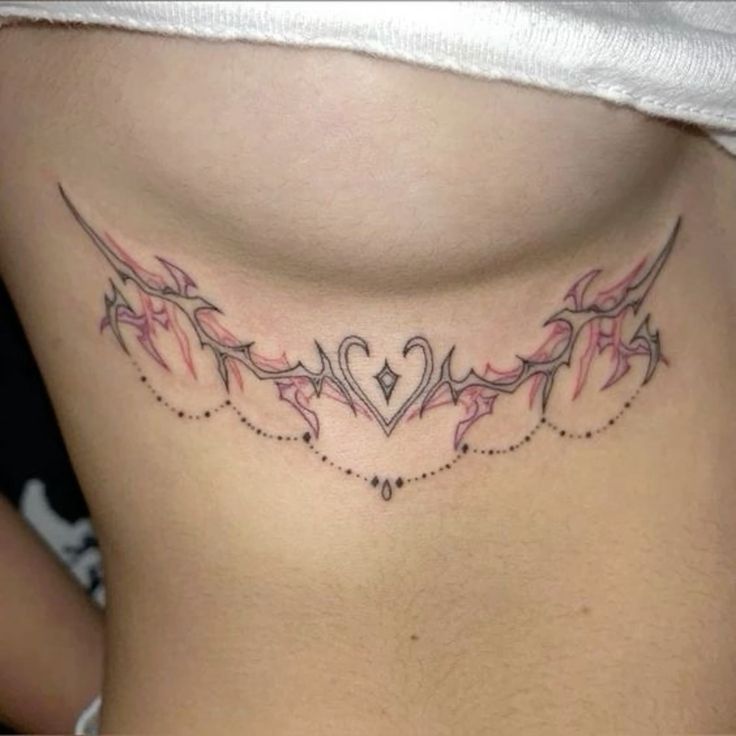 a woman's stomach with tattoos on it and an arrow in the shape of a heart