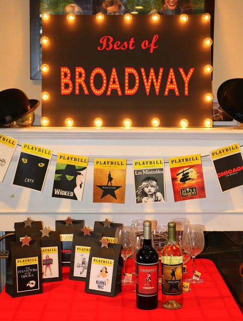 the best of broadway sign and wine glasses on display in front of a red table cloth