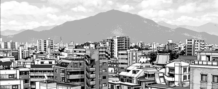 black and white photograph of cityscape with mountains in the backgrouds