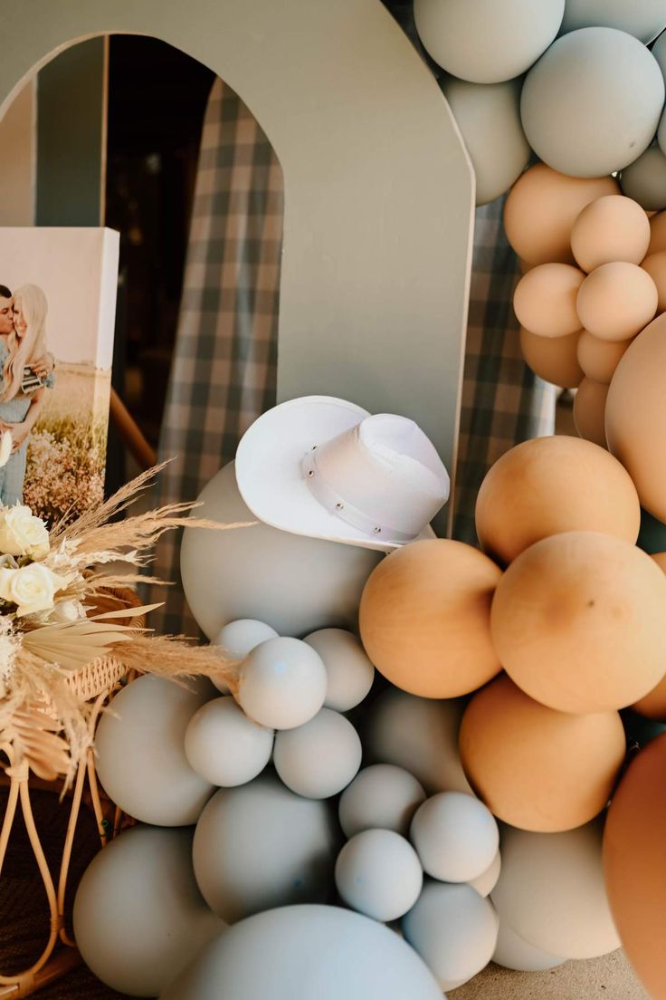 an arrangement of eggs and other items are arranged on a table with a photo in the background