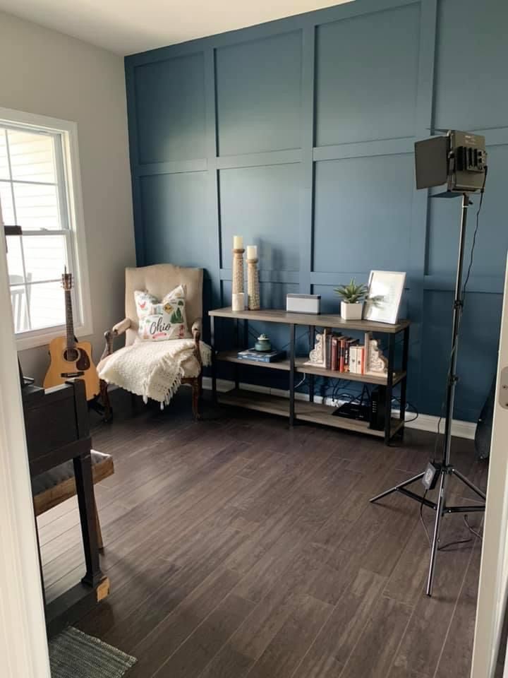 a living room with blue walls and wooden floors