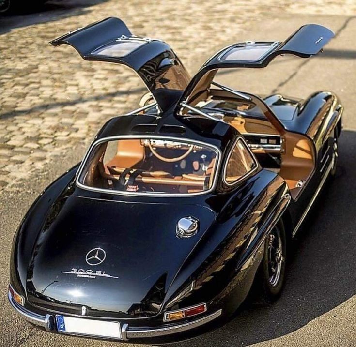 a black mercedes sports car parked on the street