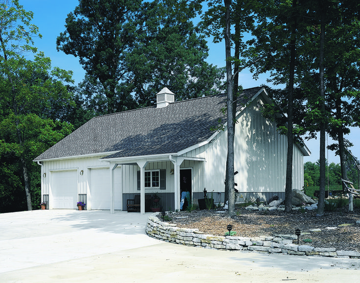 a white house surrounded by trees on a sunny day