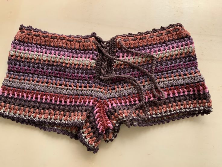 the shorts are crocheted with multicolored yarn and have draws on each side