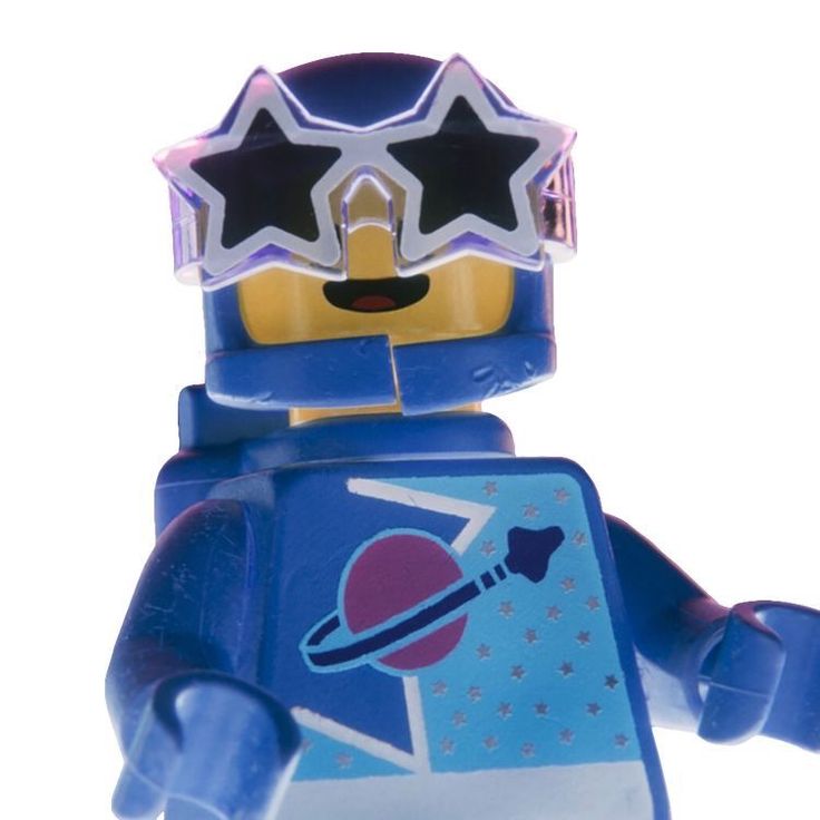 a blue lego figure with stars on his head and glasses over his eyes, standing in front of a white background