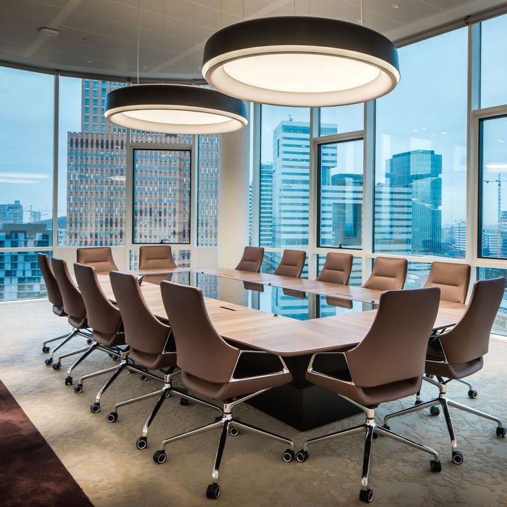 an empty conference room with large windows overlooking the city