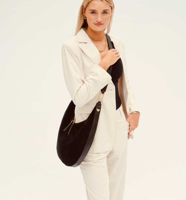 Discover our stylish suede (with leather trim) Nora Shoulder Bag. Combining the rich textures of suede and leather, this bag is destined to be a striking accessory for any occasion.  Equipped with a smart, adjustable strap, this bag can be worn comfortably over the shoulder or lengthened for a stylish crossbody look. Whether you are navigating a busy day or enjoying an evening out, this bag adapts to your needs.  Crafted with precision and care, this maxi bag offers ample space for your essentia Luxury Shoulder Bag With Leather Trim For Office, Luxury Leather Trim Shoulder Bag For Office, Modern Shoulder Bag With Suede Lining, Elegant Everyday Suede Hobo Bag, Elegant Suede Business Shoulder Bag, Chic Business Hobo Bag With Leather Handles, Chic Hobo Tote Bag For Business, Chic Business Hobo Tote Bag, Modern Suede Shoulder Bag For Evening