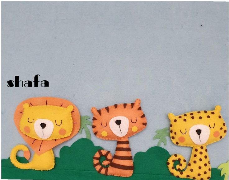 three felt animals sitting on top of a grass covered field with the word shafa written above them