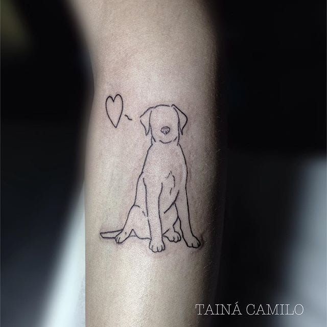 a dog with a heart tattoo on its leg