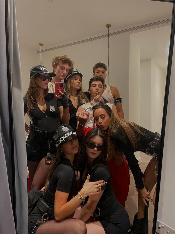 a group of people taking a selfie in a mirror