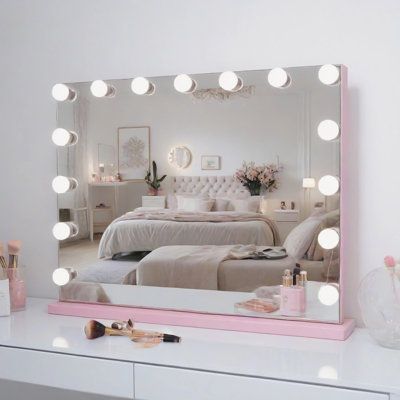 a vanity with a mirror and lights on top of it in front of a bed