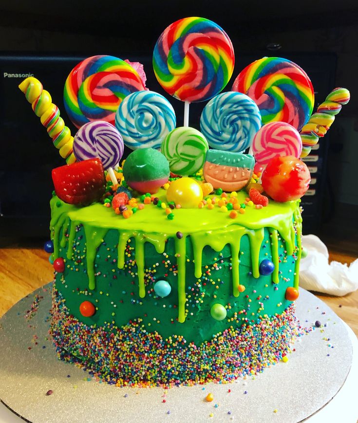 there is a cake decorated with candy and lollipops