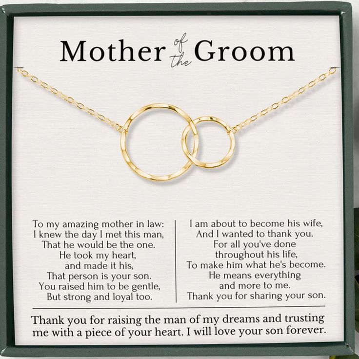 a mother and son necklace set with two interlocked rings in gold on a card