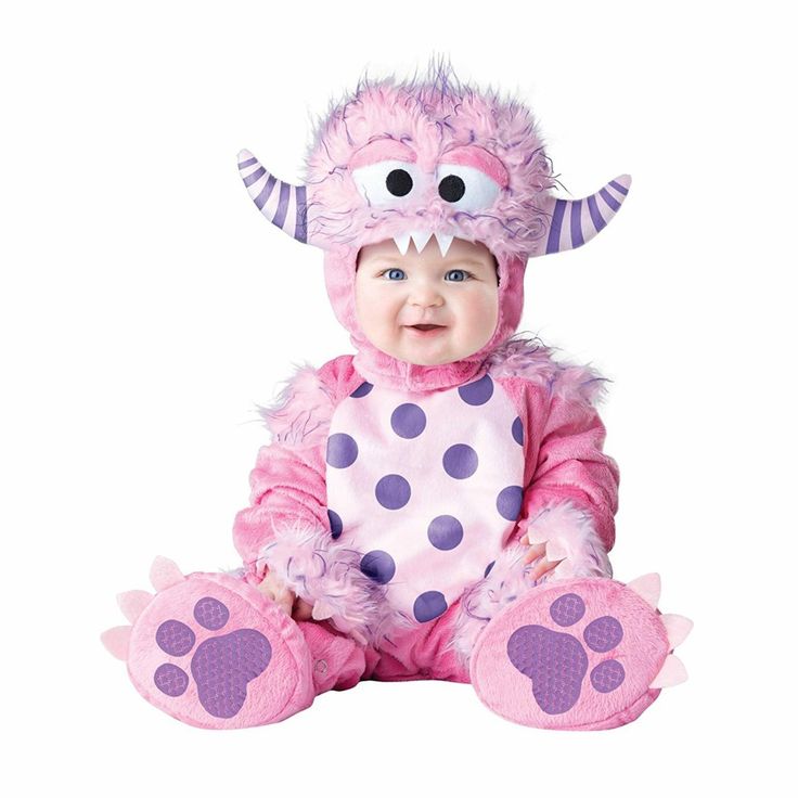 a baby dressed in a pink monster costume