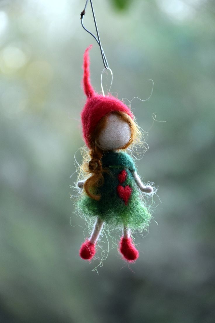 a small doll hanging from a tree branch