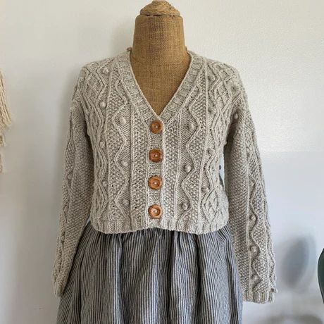 an old fashioned sweater and dress are on display